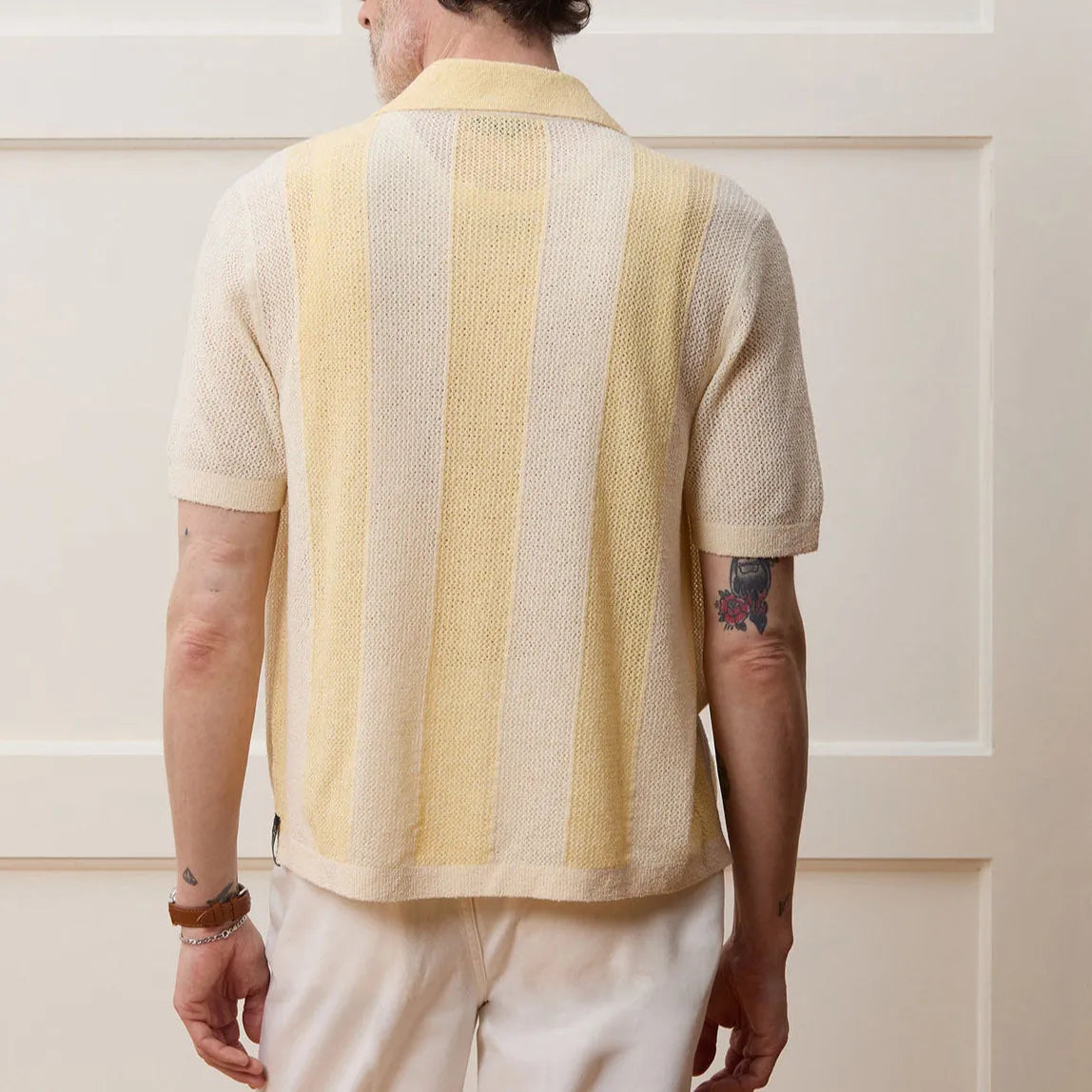 Yellow asymmetric hollow-out short sleeve polo shirt made from Tencel fabric on a model.