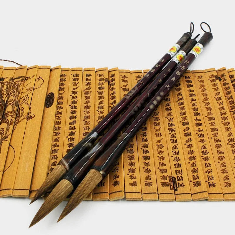 Traditional Chinese wolf hair calligraphy brushes with steel rod handles in large, medium, small, and trumpet sizes.