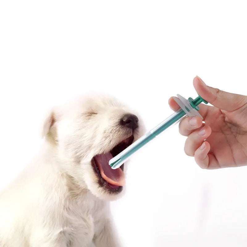 Two silicone pet pill shooters with soft tips, one larger and one smaller, for administering tablets to cats and dogs.