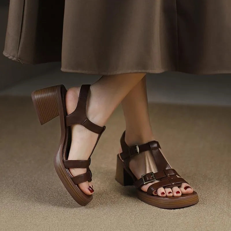 Women's black retro platform sandals with a T-shaped buckle strap and chunky heel.