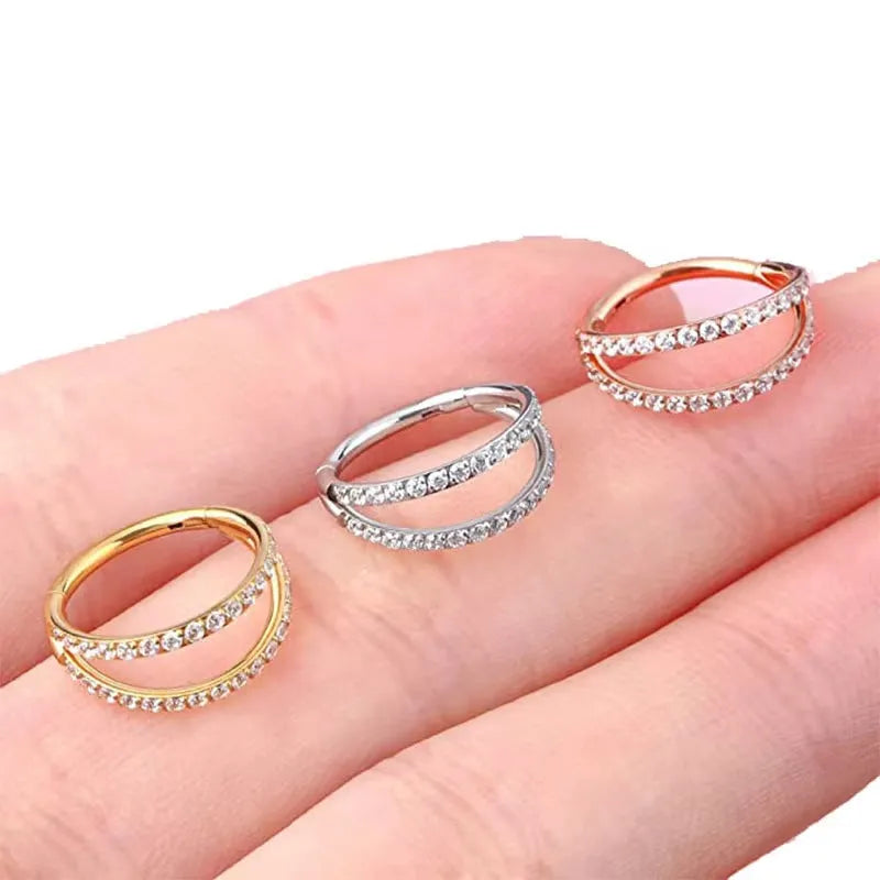 Close-up of a G23 titanium alloy nose ring with a monoclinic diamond finish, shown in steel colour and gold colour options.