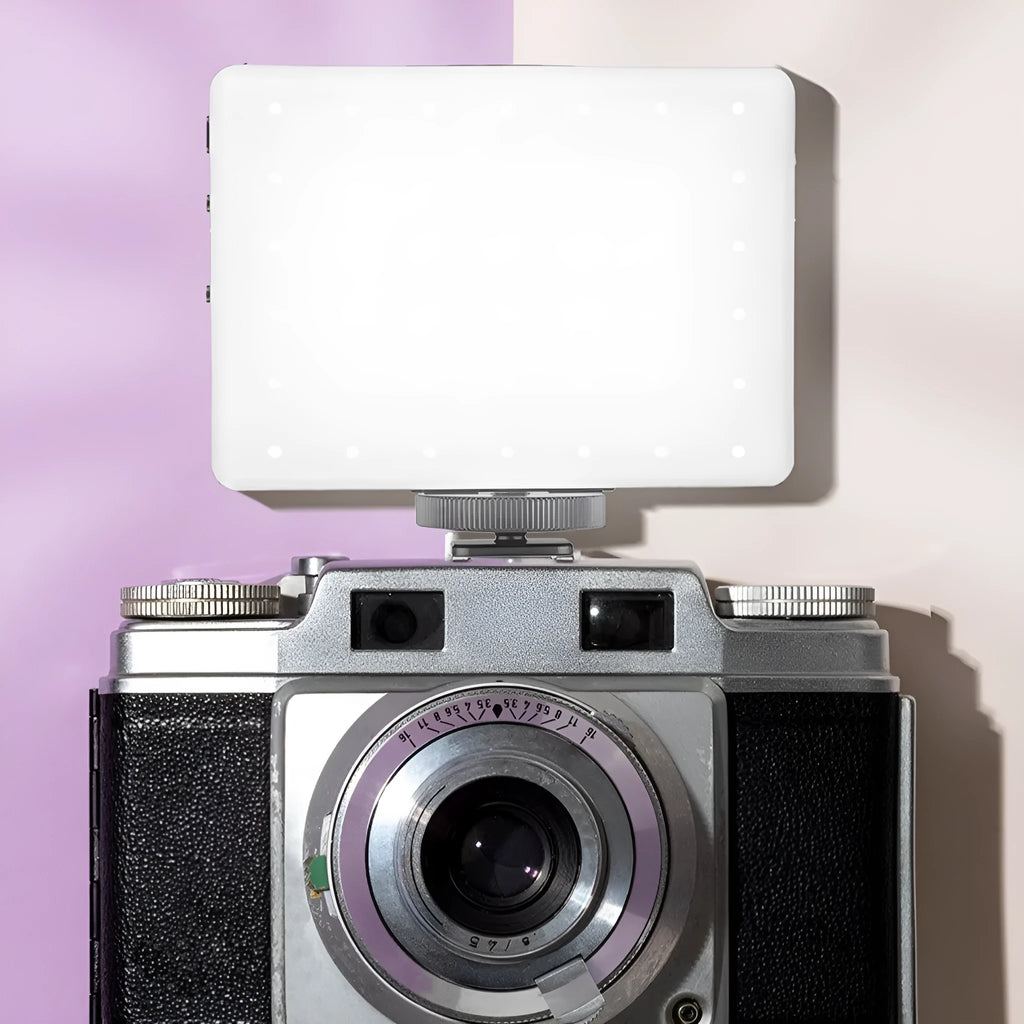 Pocket-sized handheld LED fill light with clip, shown next to a mobile phone for scale.