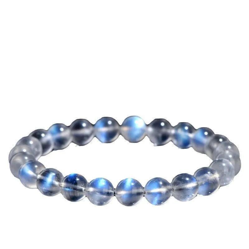 Natural cream coloured crystal bracelet on a wrist showing its simple unisex design and smooth ground beads.