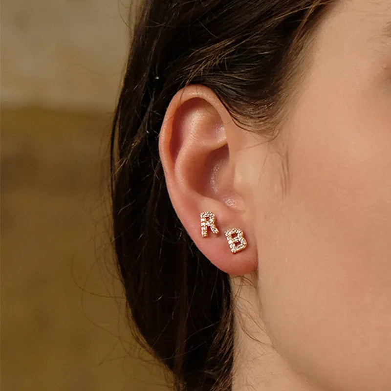 Gold plated alphabet letter stud earrings with zircon stones showing A to Z selection on copper base