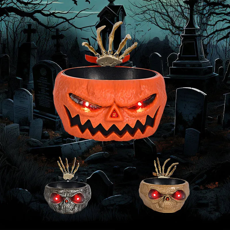 Plastic Halloween candy bowl with motion-activated skeleton hand and glowing red eyes on a table