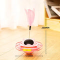 Pink plastic cat tumbler turntable stick toy with feather attachments on a white background.