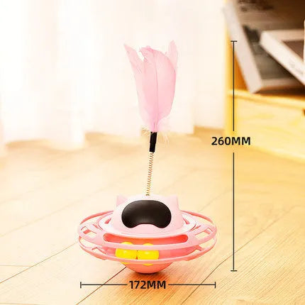 Pink plastic cat tumbler turntable stick toy with feather attachments on a white background.