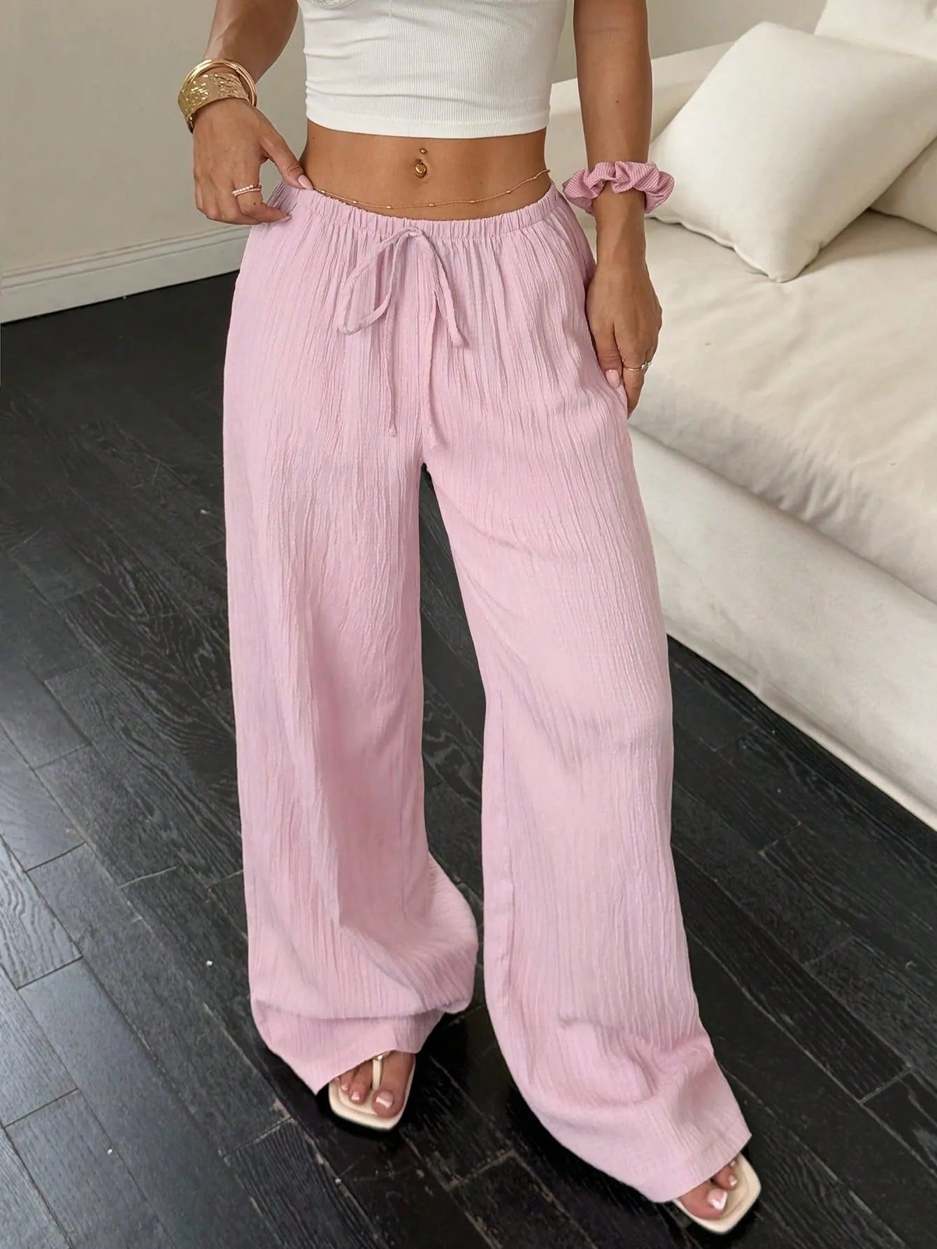 Women's black wide leg trousers with lace-up waist trimming detail on mid-waist