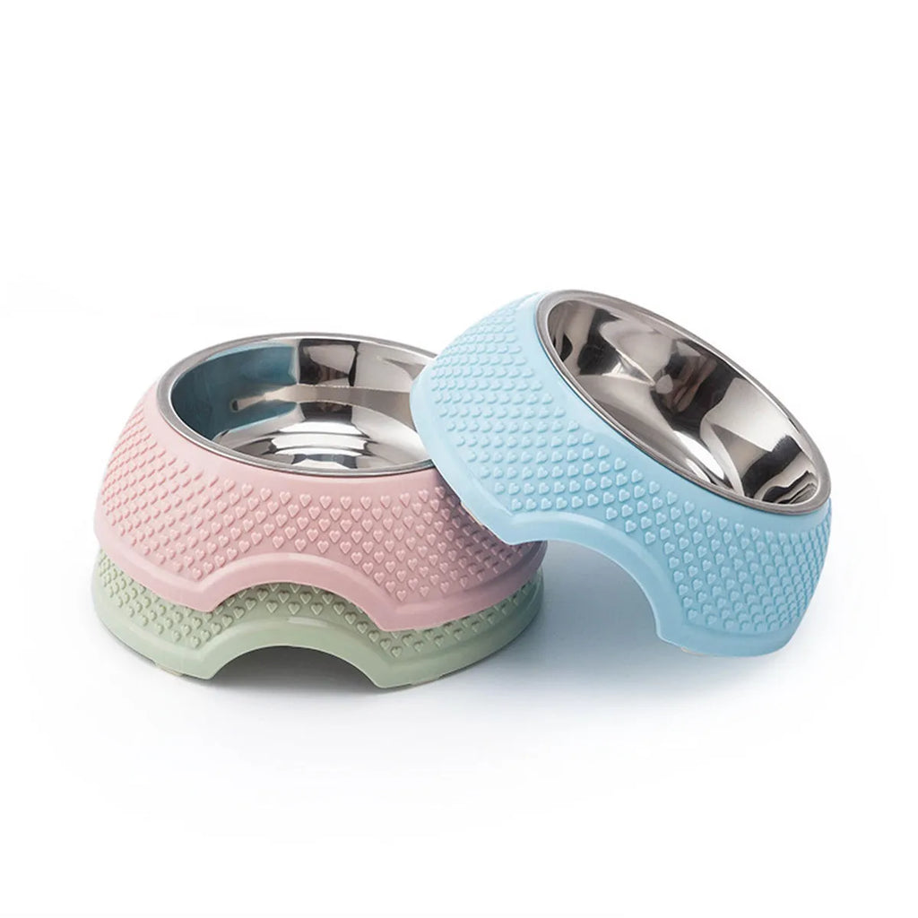 Blue stainless steel pet bowl with non-slip base for cats and dogs on a kitchen floor.