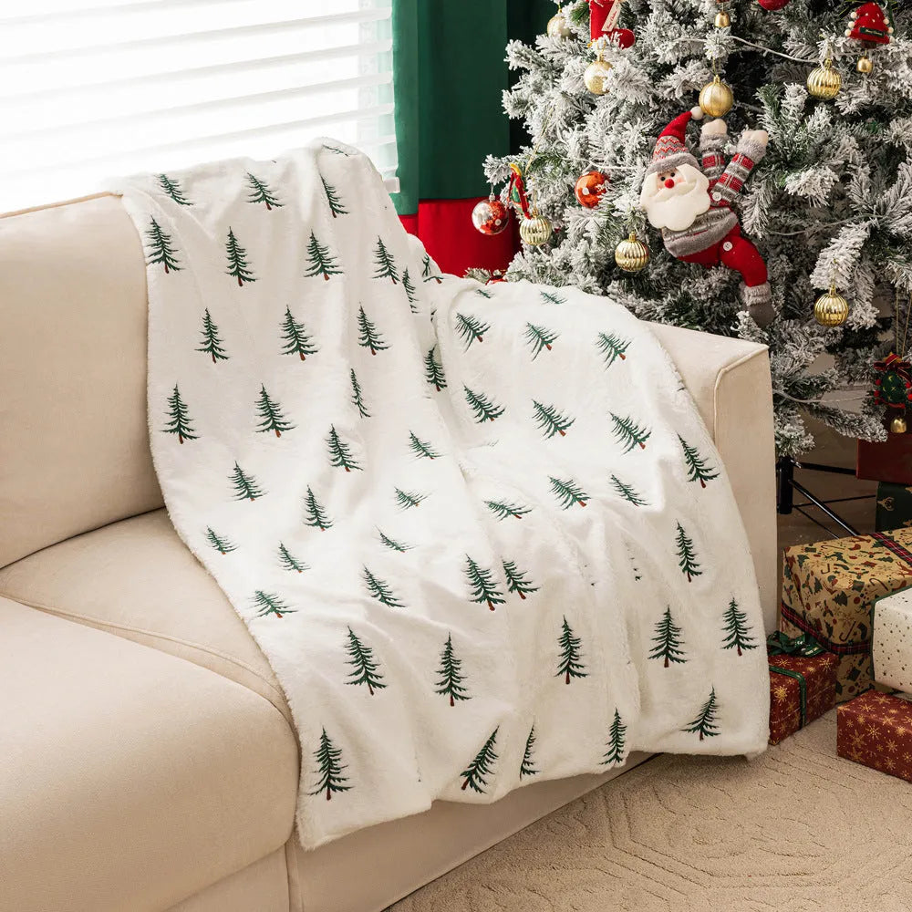 White polyester Christmas plush sofa blanket with embroidered Christmas tree on a sofa