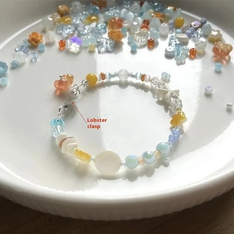 Orange mixed material women's bracelet with diamond shape and round decorative elements