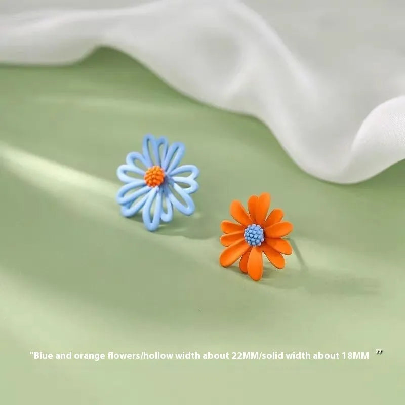 Women's alloy cartoon flower stud earrings showing blue and orange, white and green, and yellow and white colour combinations
