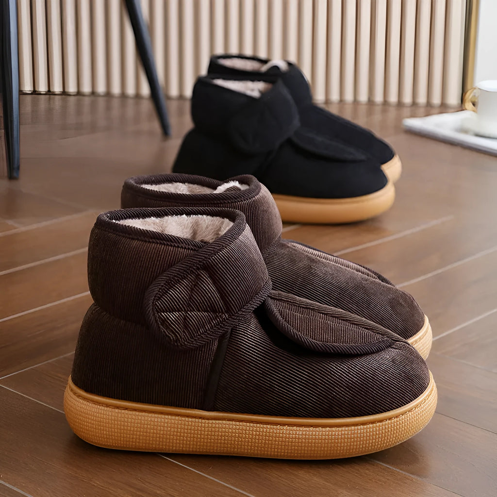 Large opening warm boots with anti-slip rubber soles, unisex slip-on design, plush upper and faux fur lining in black