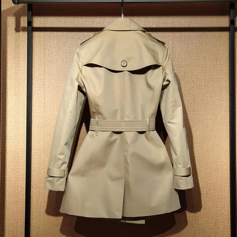 Khaki women's double breasted trench coat with flight sleeves and button detailing.