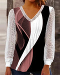 Purple loose V-neck top with lace print detail, long sleeves, on a hanger.