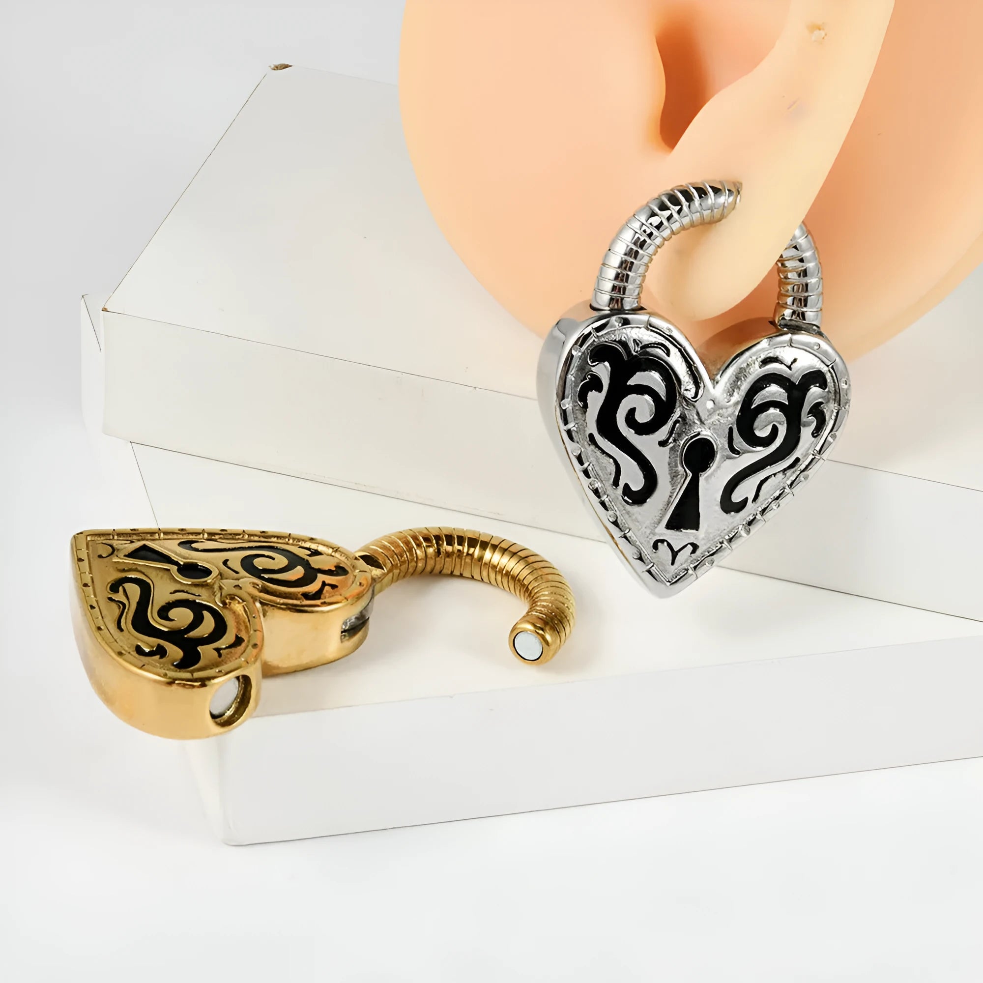 A pair of heart-shaped stud earrings in stainless steel with a choice of gold or steel electroplated colour.