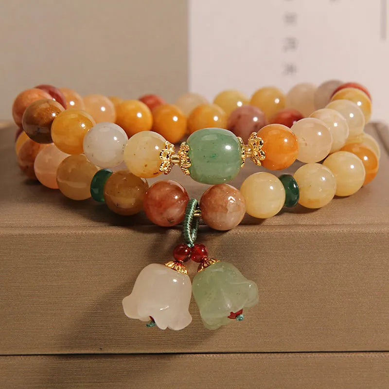 Natural jade multi-layer bracelet for women with a white orchid pendant charm on an elasticated cord