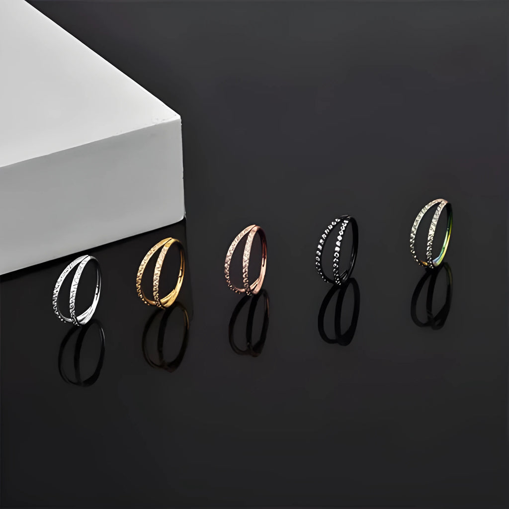 Close-up of a G23 titanium alloy nose ring with a monoclinic diamond finish, shown in steel colour and gold colour options.