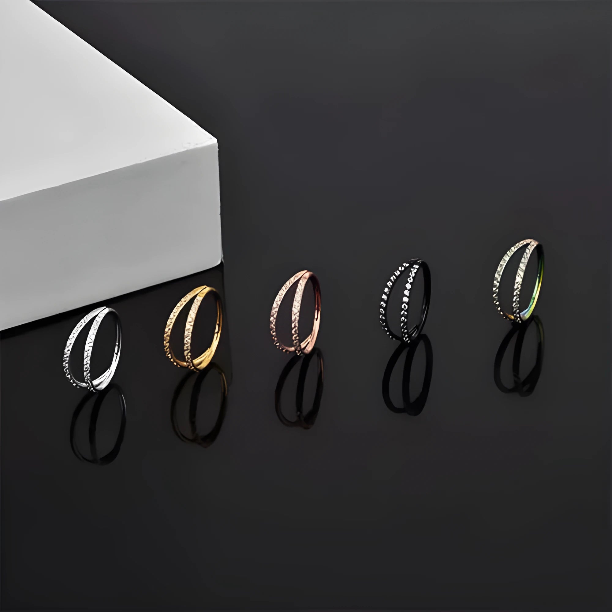 Close-up of a G23 titanium alloy nose ring with a monoclinic diamond finish, shown in steel colour and gold colour options.