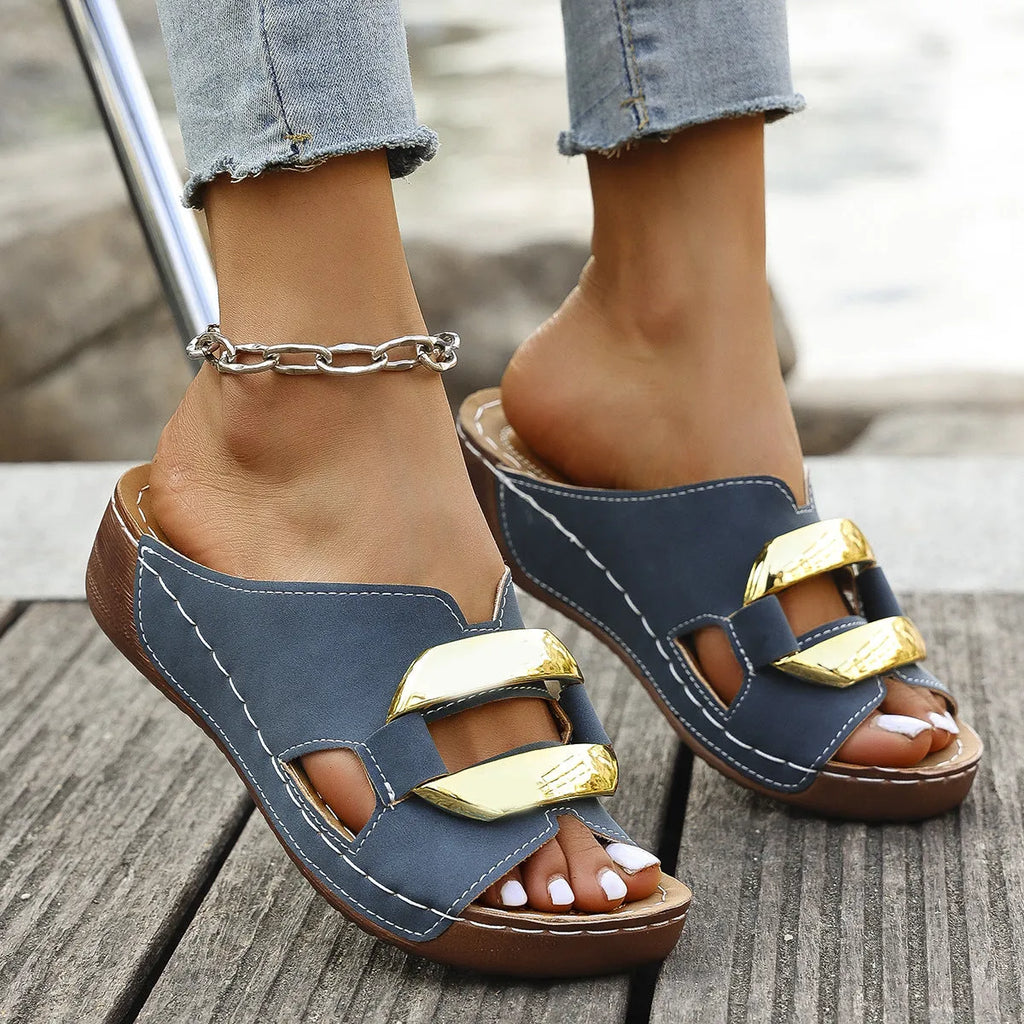 Pair of Roman-style platform flip-flop sandals on a solid colour background.
