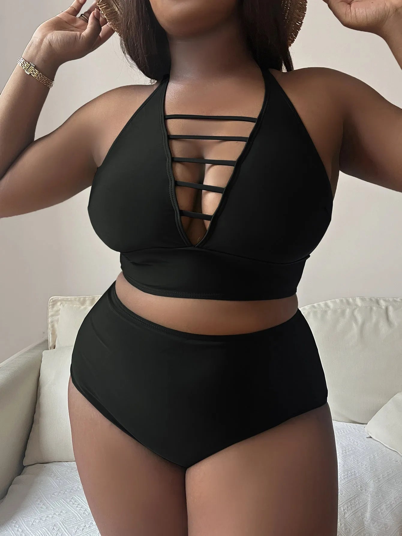 Plus size black halter bikini with adjustable cross straps and high waist briefs on mannequin
