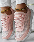 Women's white canvas sports shoes with round toe and flat heel on a neutral background.
