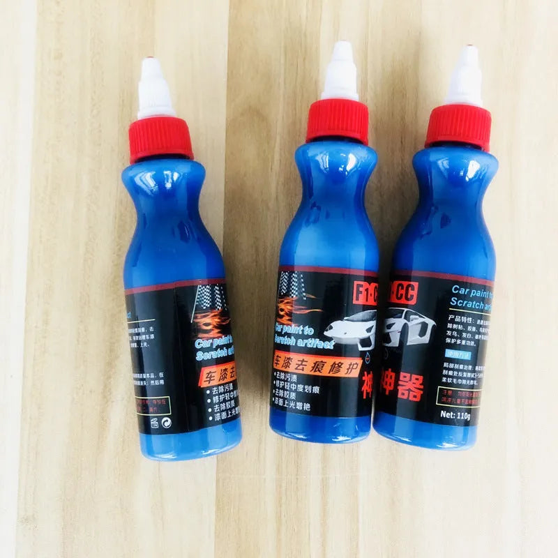 Small blue automotive scratch repair kit with repair agent bottle and applicator sponge for car paint damage