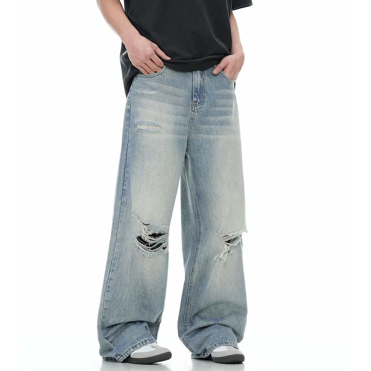 Blue men's straight-leg ripped jeans on a neutral background, showing the cotton blend fabric and zipper fly detail.