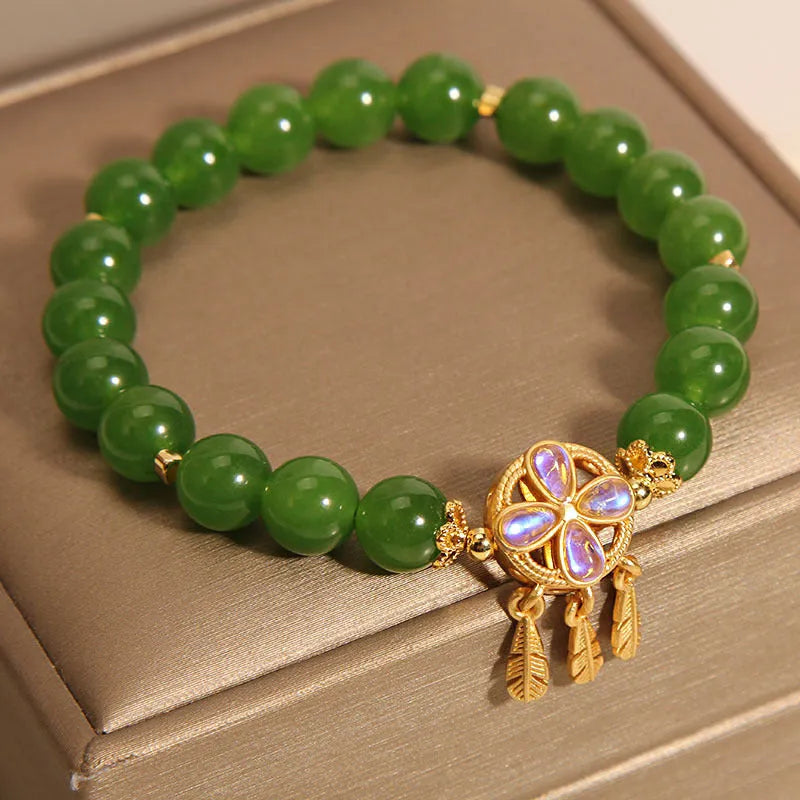 Green jasper bracelet for women with a four-leaf clover dream catcher crystal pendant on a chain.