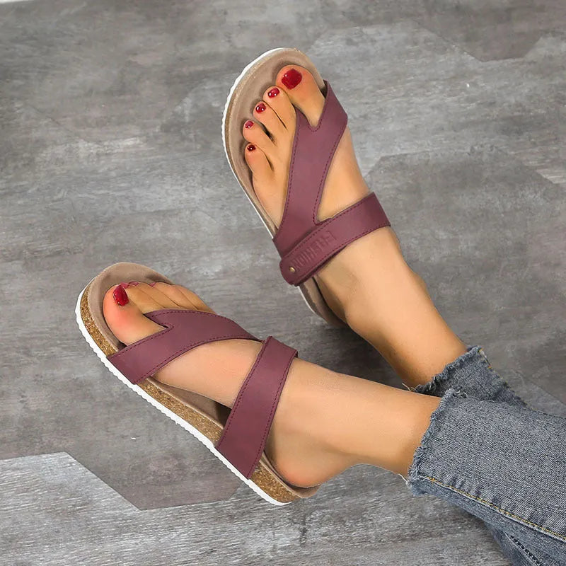 Blue thick-soled flat flip-flops with a toe ring on a foam sole.