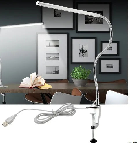 Silver long arm LED clip table lamp with USB cable, shown illuminating a nail art workspace.