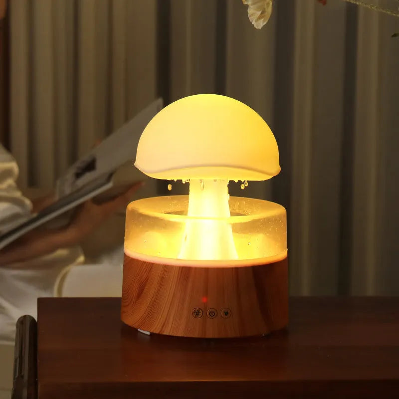 White cloud-shaped humidifier emitting mist with LED lights and falling water droplets
