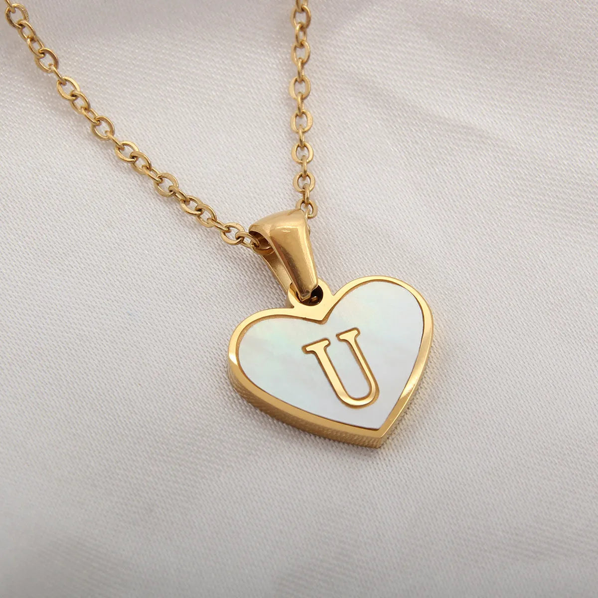 Gold plated heart necklace with white shell detail on an adjustable chain