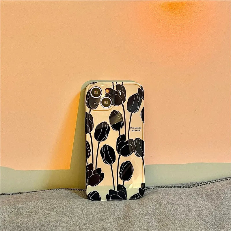 Black silicone iPhone case with intricate cold wind tulip pattern design on back cover