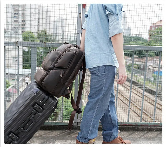 Dark brown retro leather backpack for men showing front view and open compartments.