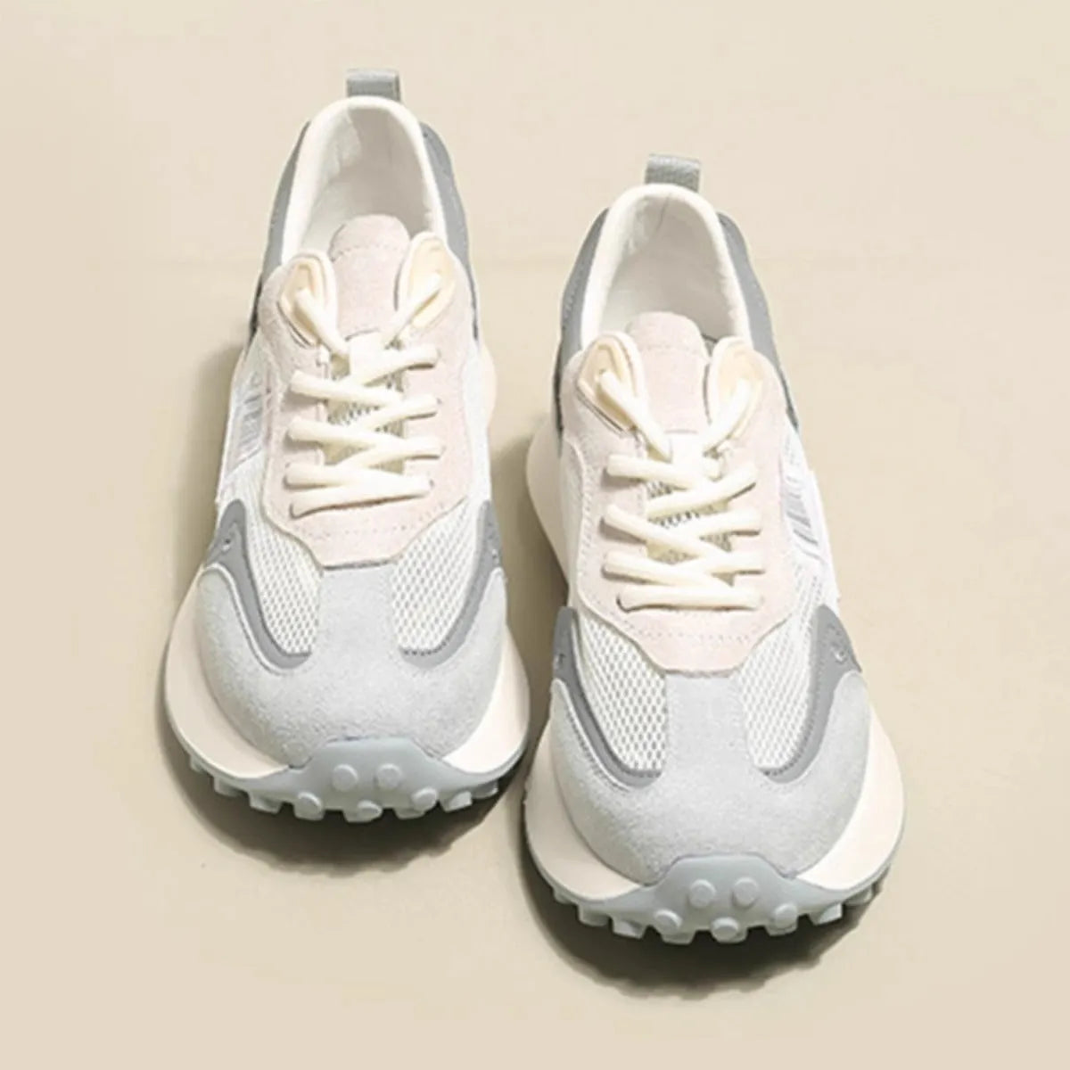 Women's grey and pink retro sneakers with low-top design and rubber sole
