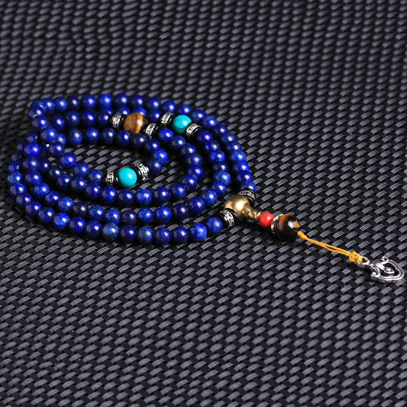 Natural Lapis Lazuli 108 bead bracelet in 8mm size on unisex wrist showing deep blue stone beads