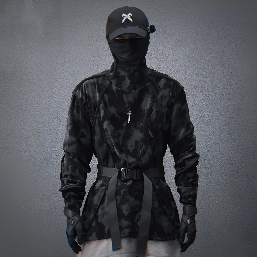 Men's black tie dye patterned pullover sweater with turtleneck and drop shoulders on a grey background.