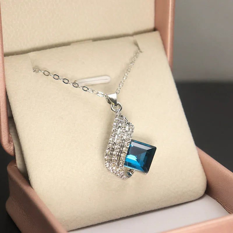 Necklace and earrings jewellery set with alloy pendant and glass details on cross chain