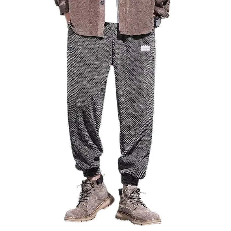 Men's grey straight-leg sweatpants with ankle ties on a hanger