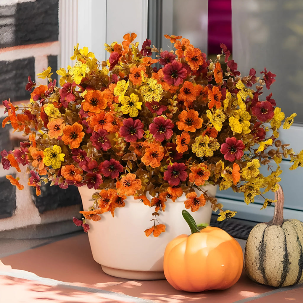 Artificial silk flower bouquet in autumn colours of red, yellow, and orange for wedding and home decoration