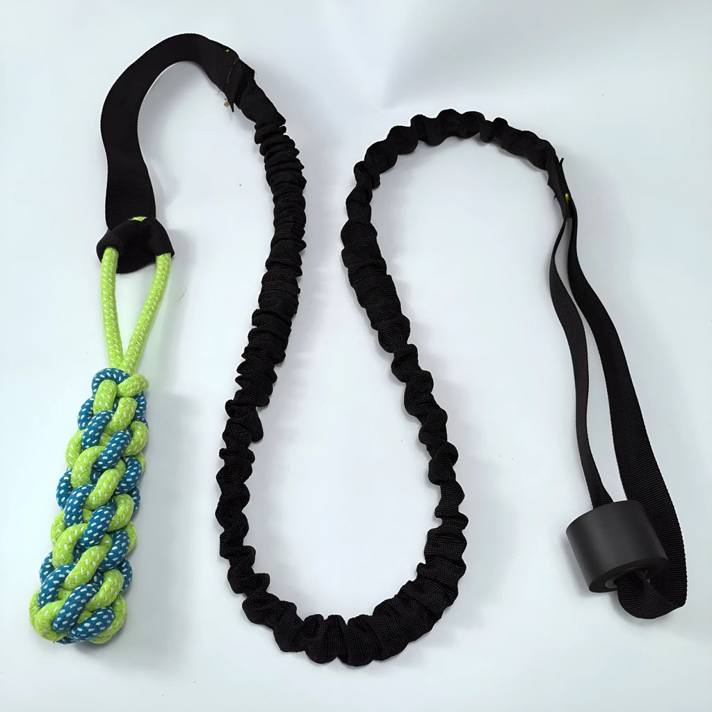 Green cotton dog tug rope toy with a textured teether ball attached for bite and pull play.