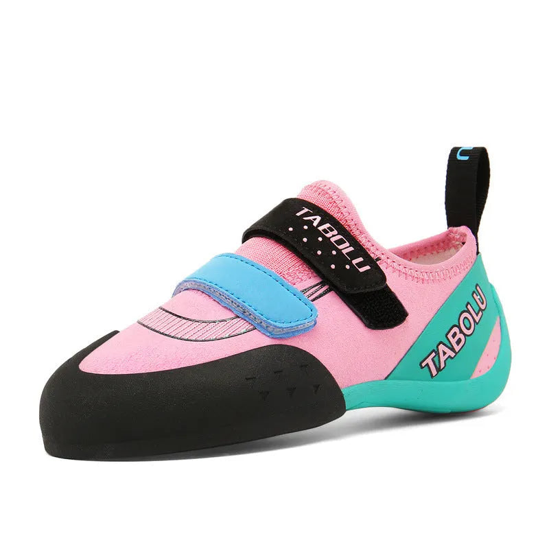 Beginner rock climbing shoes with Velcro strap and rubber sole in black and red colour.
