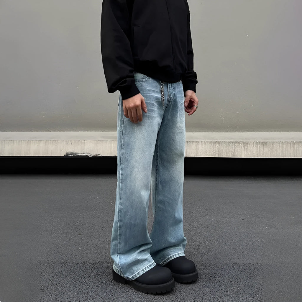 Men's blue straight leg jeans with a retro whisker wash, showing flared leg and visible stitching.