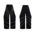 Men's black trousers with three-dimensional cut, metal striped rivet details and pleats on a white background.