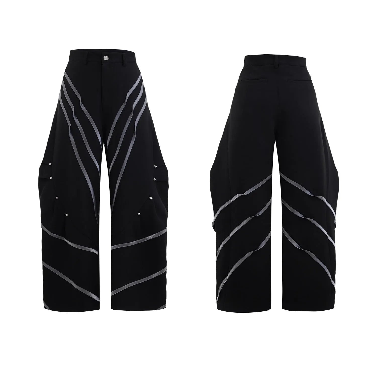 Men's black trousers with three-dimensional cut, metal striped rivet details and pleats on a white background.