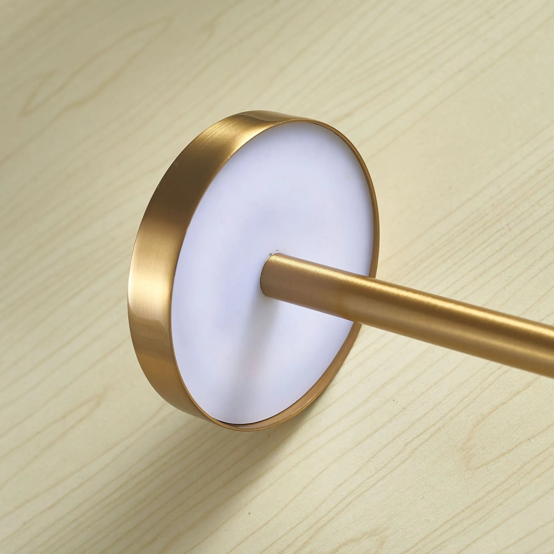 Metal touch desk lamp in gold finish with LED light on, showing compact 34x8cm size