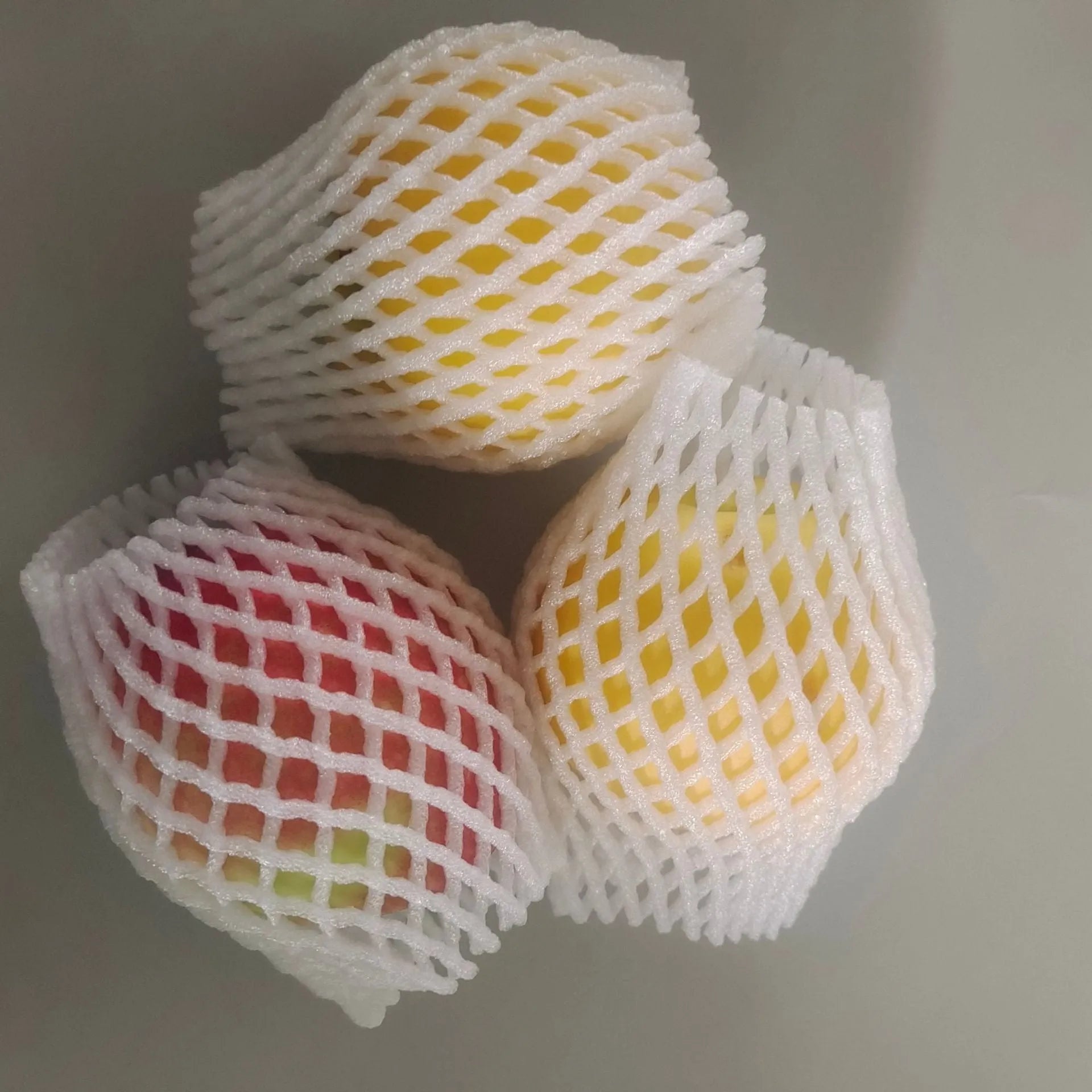 White foam fruit net cover shown in various sizes for protective wrapping.