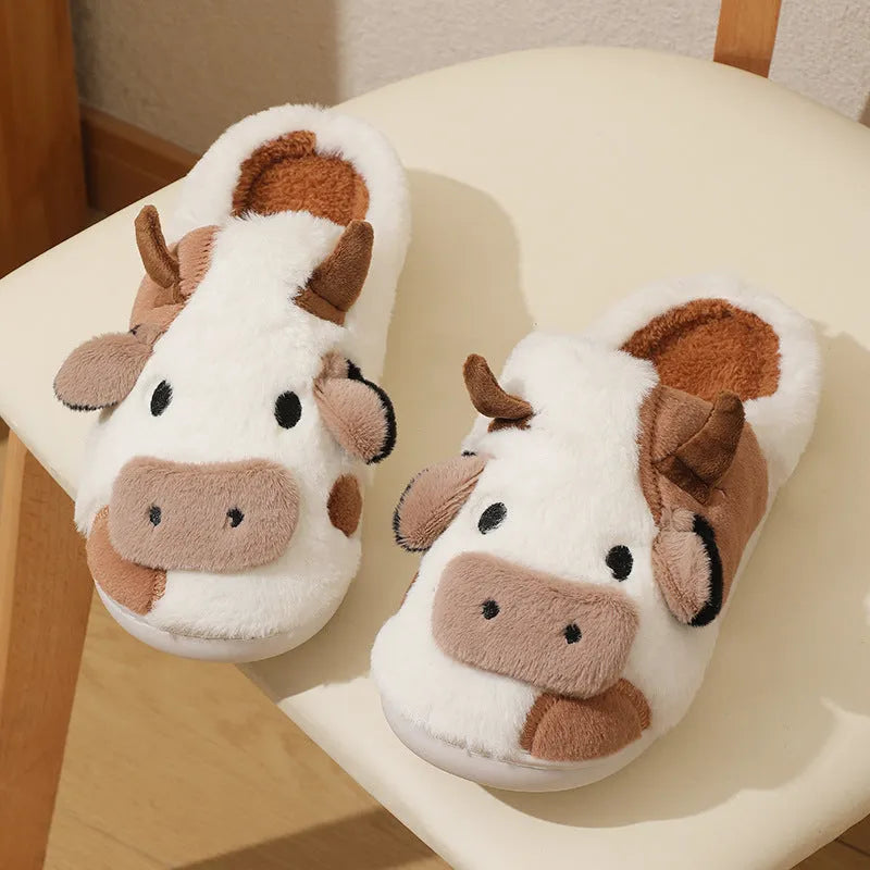White cow print faux fur plush slippers for women with a non-slip textured sole.