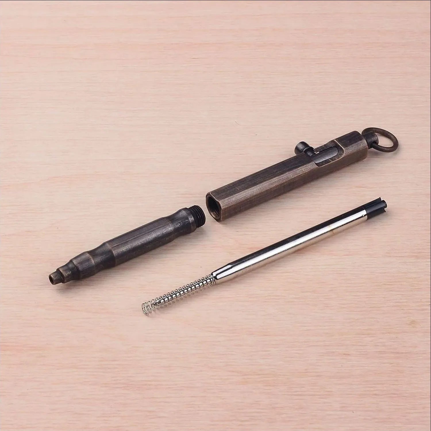 Brass tactical pen with hexagonal machine gun bolt design measuring 13cm length